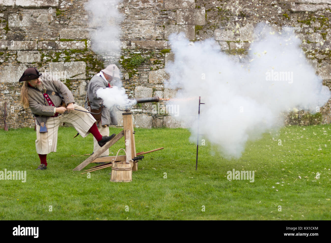 Pirates firing a gun at a Cabbage to demonstrate the power and force at Pendennis castle Stock Photo