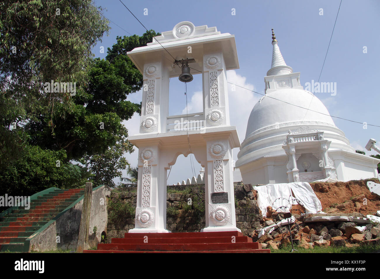 Stupa, bell tower and staircase in Sapugoda temple in Beruwala, Sri Lanka Stock Photo