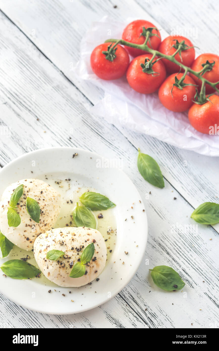 Mozzarella with cherry tomatoes and basil leaves Stock Photo - Alamy