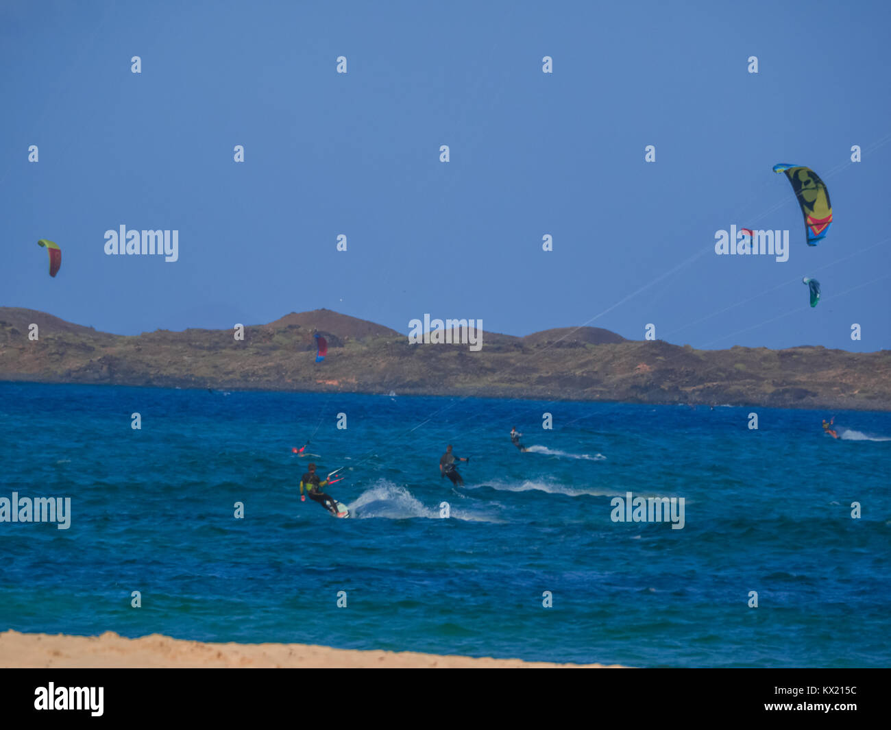 kitesurfing in Fuerteventura, Spain, guaranteed fun riding the ocean waves pushed by the wind Stock Photo