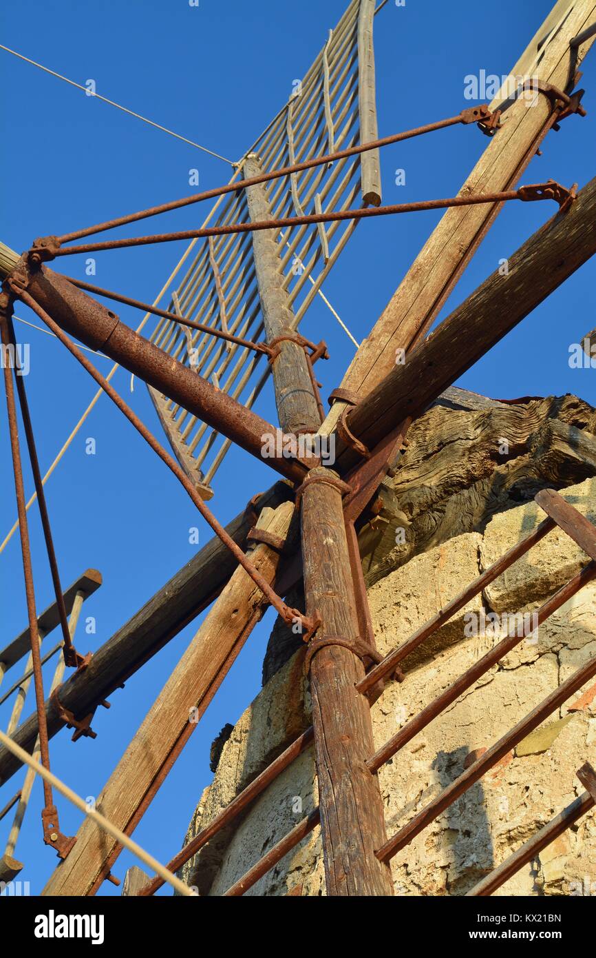 Closeup detail of a traditional windmill of the salt flats in Trapani, Sicily, with the focus on its wooden blades. Stock Photo