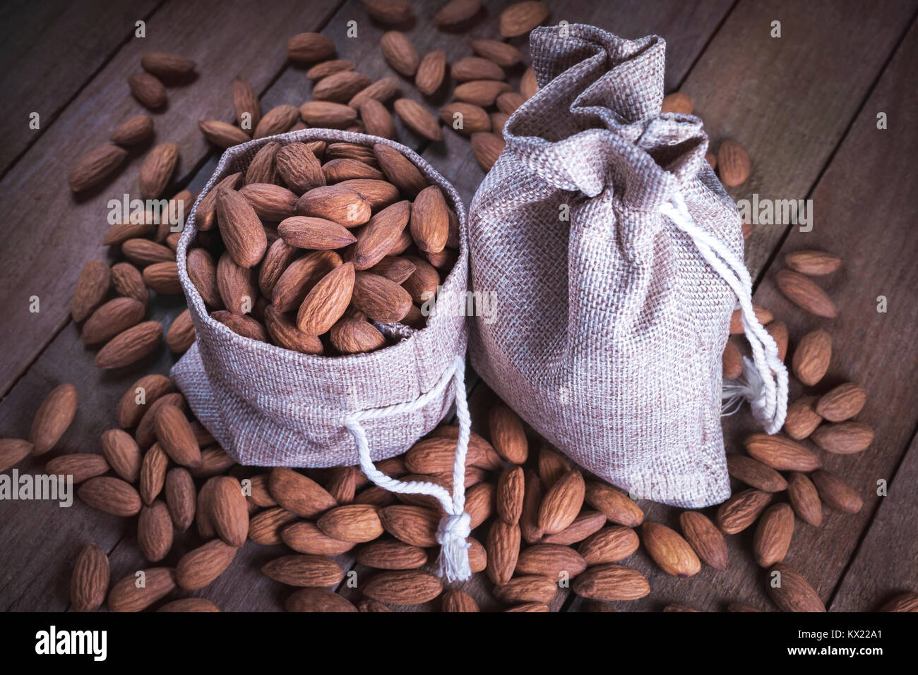 Almonds in hessian sack. Stock Photo