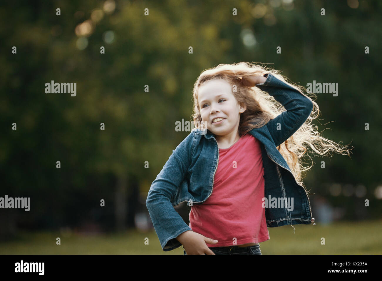 Pretty smiling child posing in park Stock Photo - Alamy