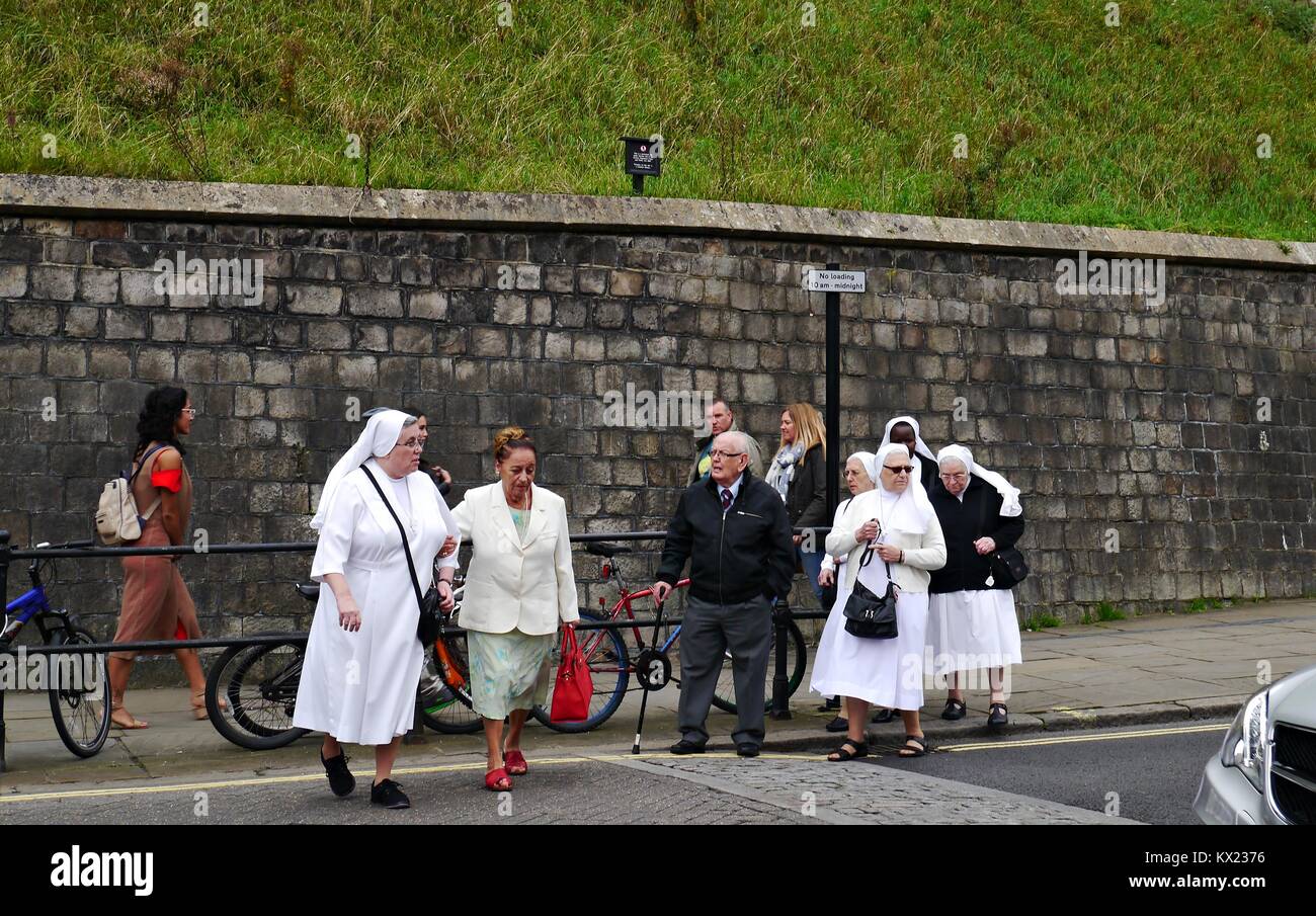 A group of nuns crossing a road near Windsor Castle in Windsor Berkshire Stock Photo