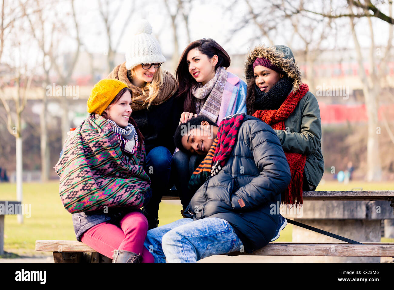 Beautiful young people sitting together in the park Stock Photo