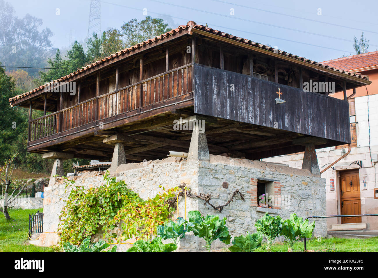 GALLEGOS, SPAIN - OCTOBER 31, 2017: Asturian granary (horreo) in the garden in Gallegos, Asturias, Spain Stock Photo