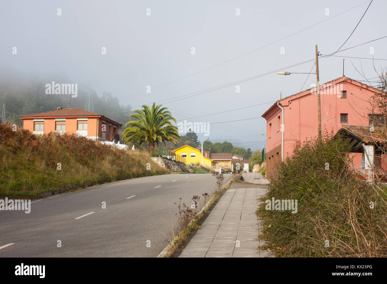 Pink houses along the road in Gallegos, Asturias, Spain Stock Photo