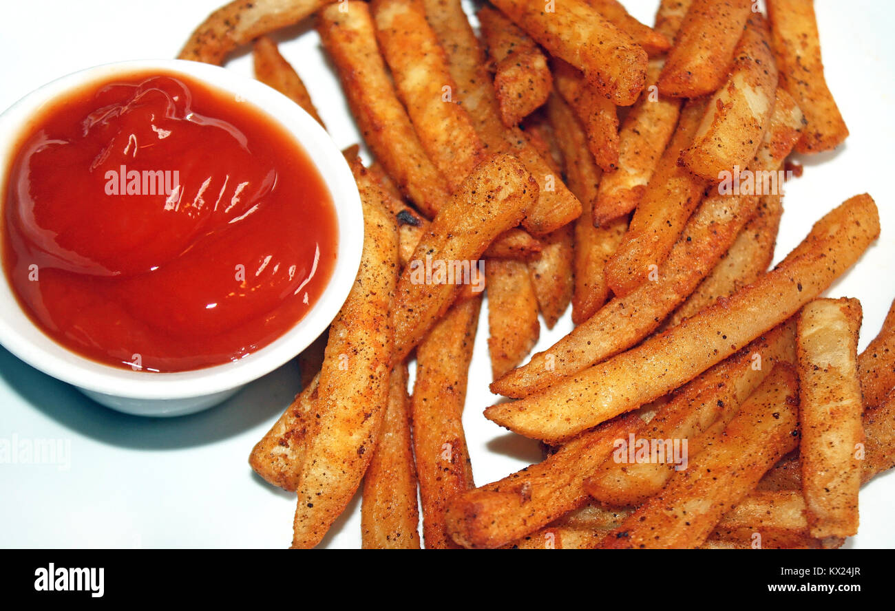 Oven baked Spicy fries with a side of ketchup for dipping Stock Photo