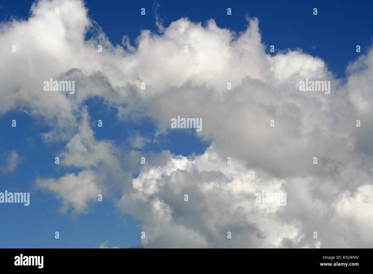 White fluffy clouds in a bright blue sky Stock Photo - Alamy