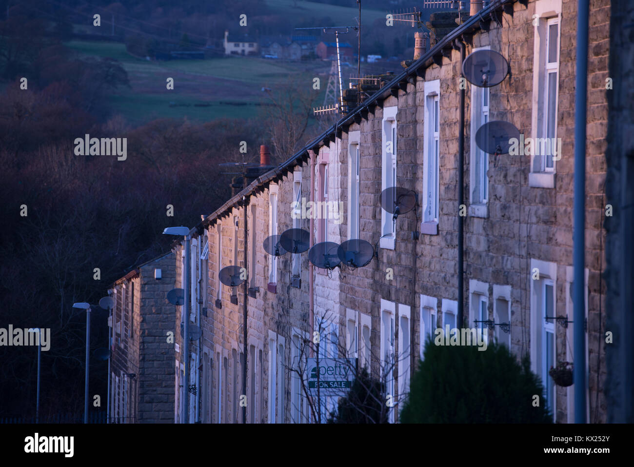 A row of terraced houses with satellite dishes in Nelson, Lancashire Stock Photo