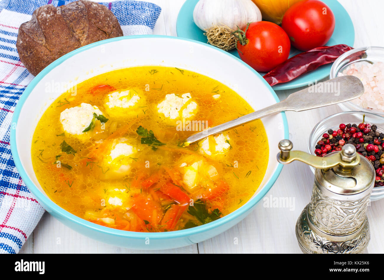 Plate of soup with meatballs on white wooden table Stock Photo