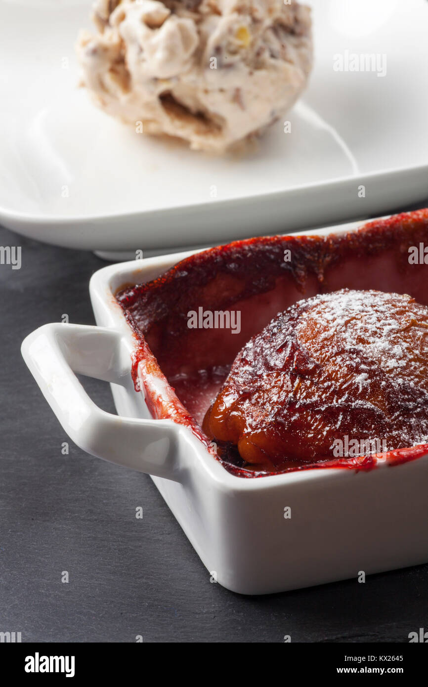 poached pear in red wine with ice cream Stock Photo