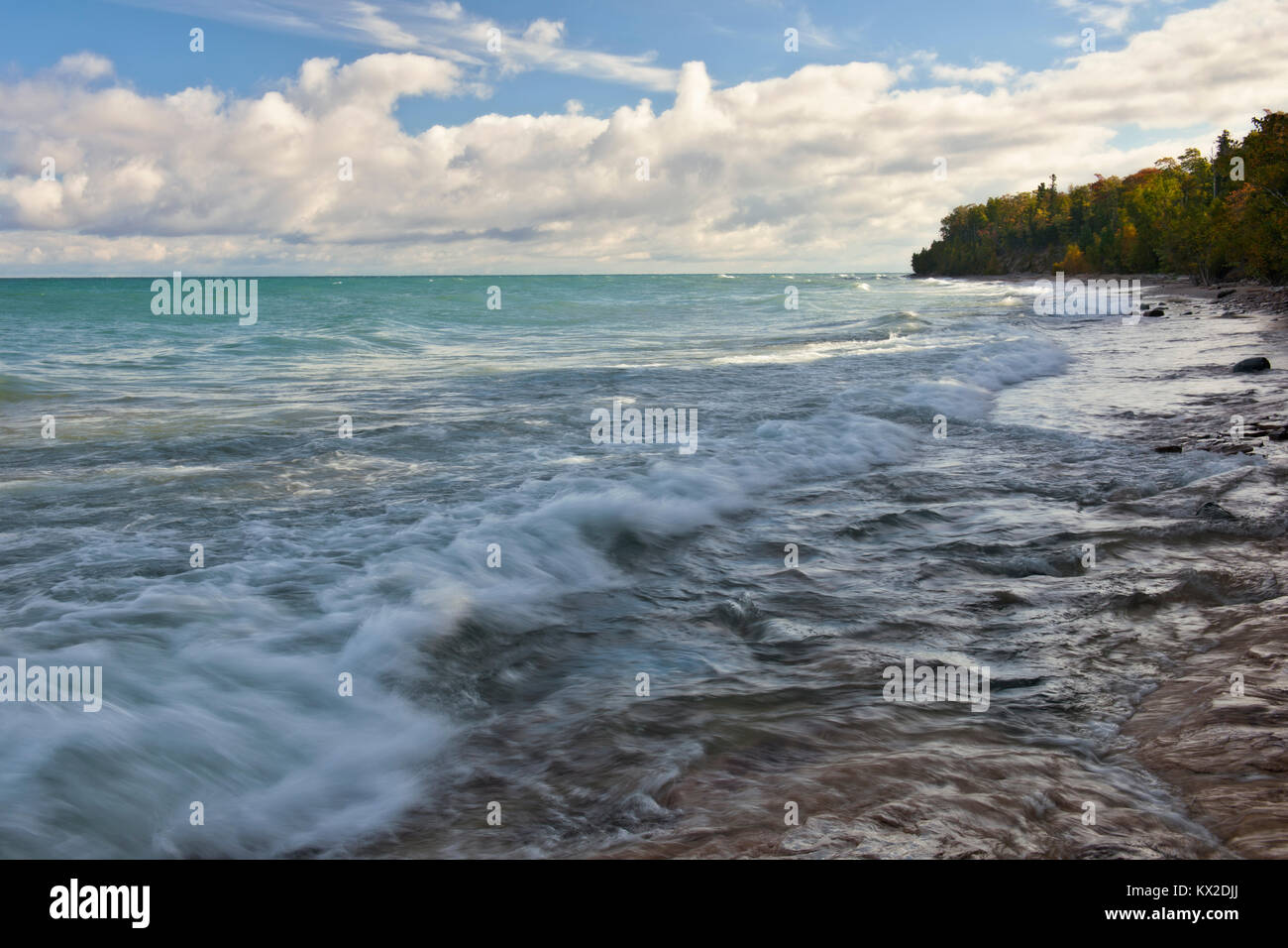 Beautiful autumn clouds pass over Lake Superior and the Shipwreck Coast along Pictured Rocks National Lakeshore in Michigan’s Upper Peninsula. Stock Photo
