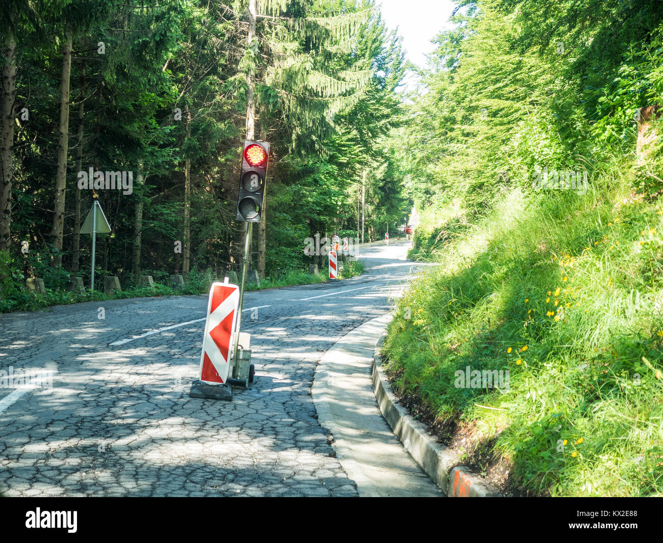 red signal at a construction site on a small road in the alps Stock Photo