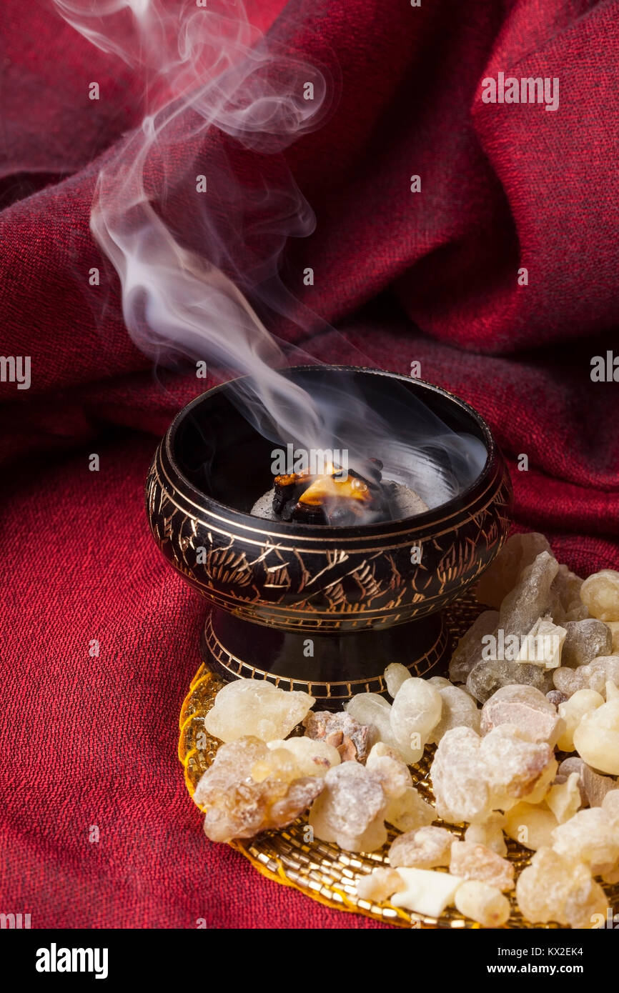 Frankincense burning on a hot coal. Frankincense is an aromatic resin