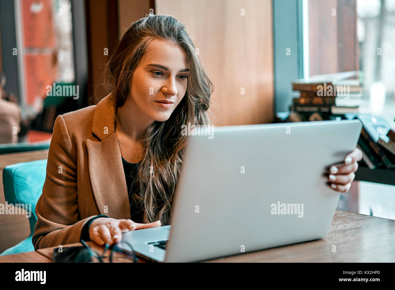 girl working with laptop in cafe Stock Photo