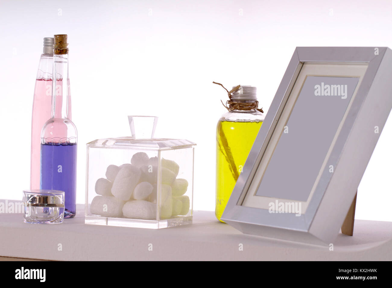 some of aromatic liquid cosmetics with a box of cotton and a frame
