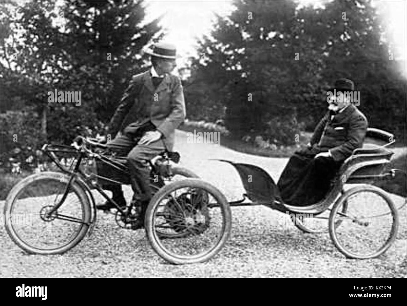 De Dion-Bouton tricycle towing a passenger in a carriage Stock Photo - Alamy