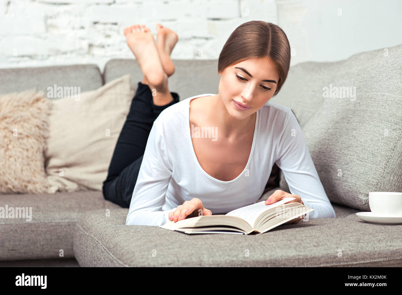 Barefoot girl lying on couch hi-res stock photography and images - Alamy
