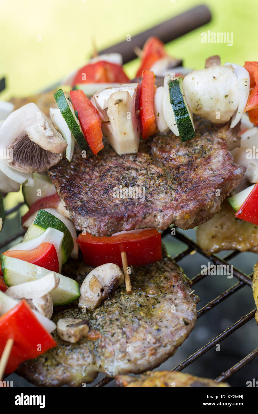 barbecue with delicious grilled meat and vegetables on grill Stock ...