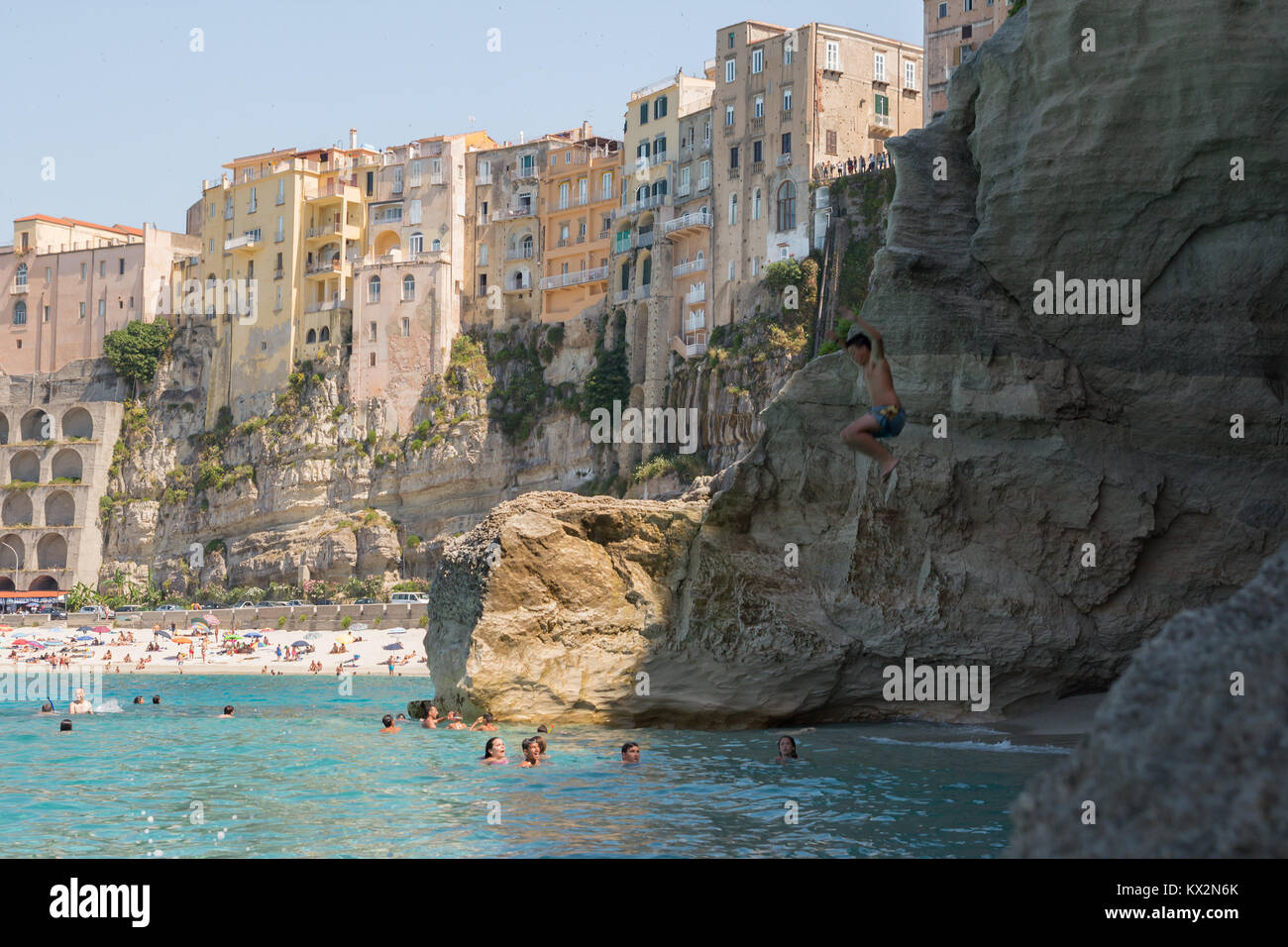 Tropea, Italy - June 2013: people swimming on the beach in popular summer destination, Tropea, Italy. Stock Photo