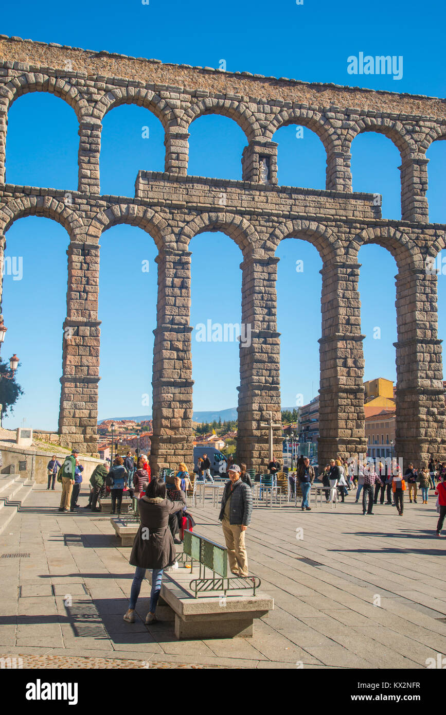 Tourists and Roman aqueduct. Azoguejo Square, Segovia, Spain. Stock Photo