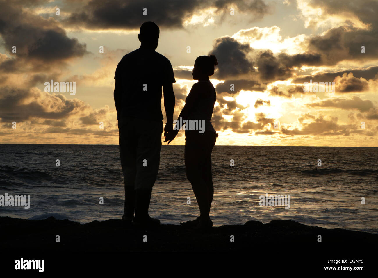 Couple on beach at sunset Costa Rica Pacific coast, the Osa Peninsula Stock Photo