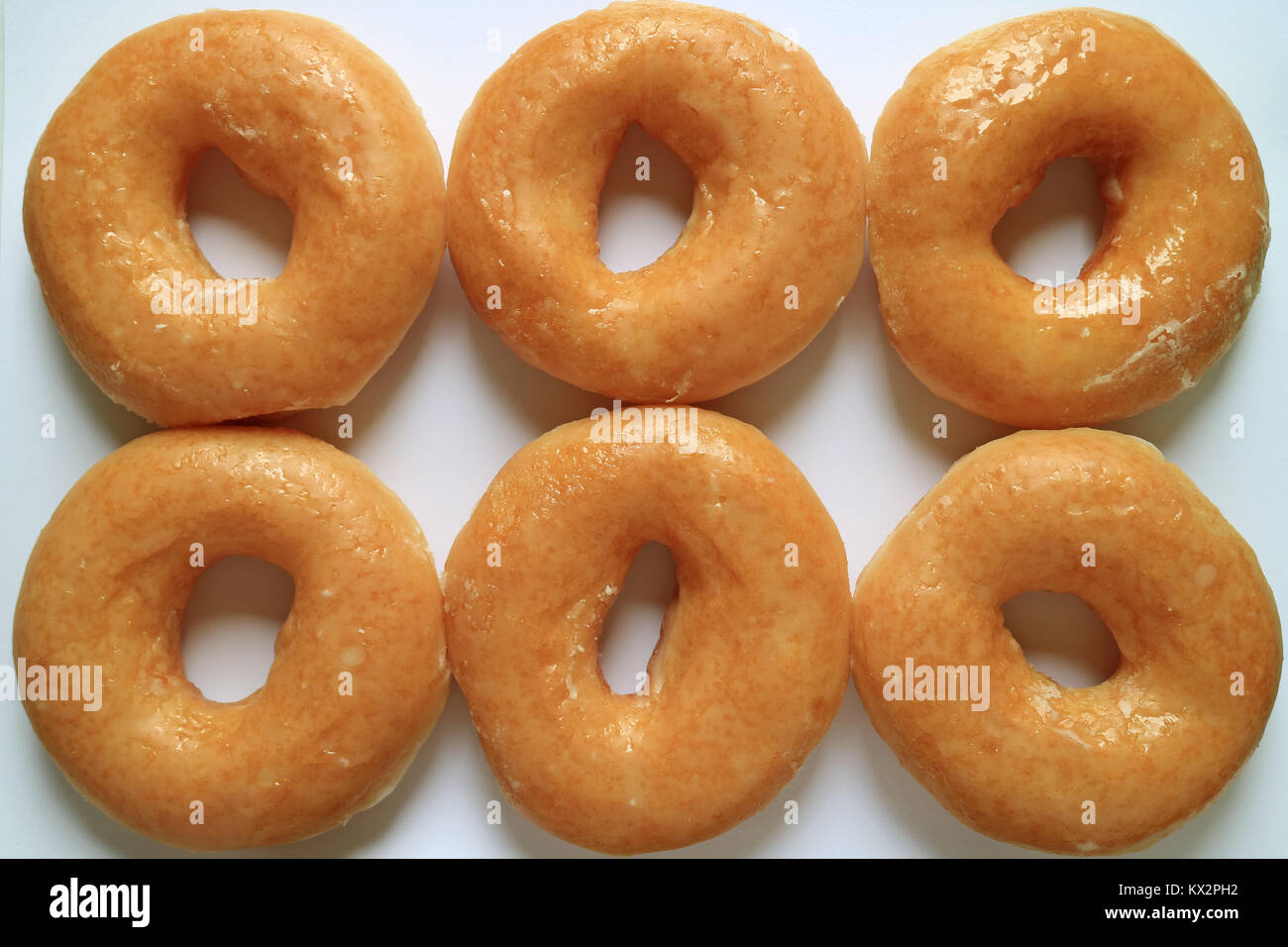 Top view of six sugar-glazed doughnuts, for background Stock Photo - Alamy