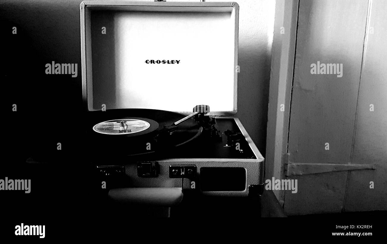 Crosley retro style portable record player with vinyl album Stock Photo