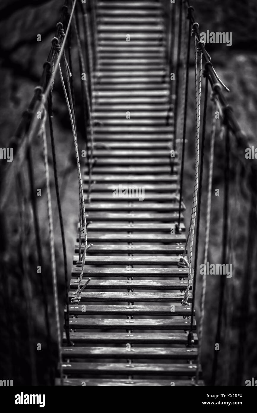 Suspension bridge in the mountains Stock Photo - Alamy