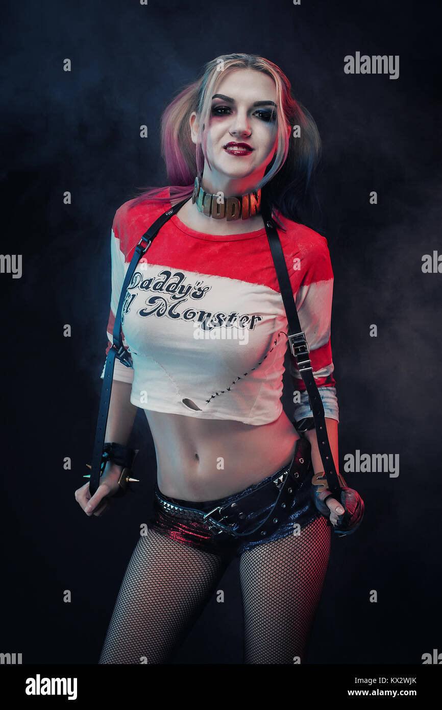 Cosplayer girl with in Harley Quinn costume. Halloween make up. Stock Photo