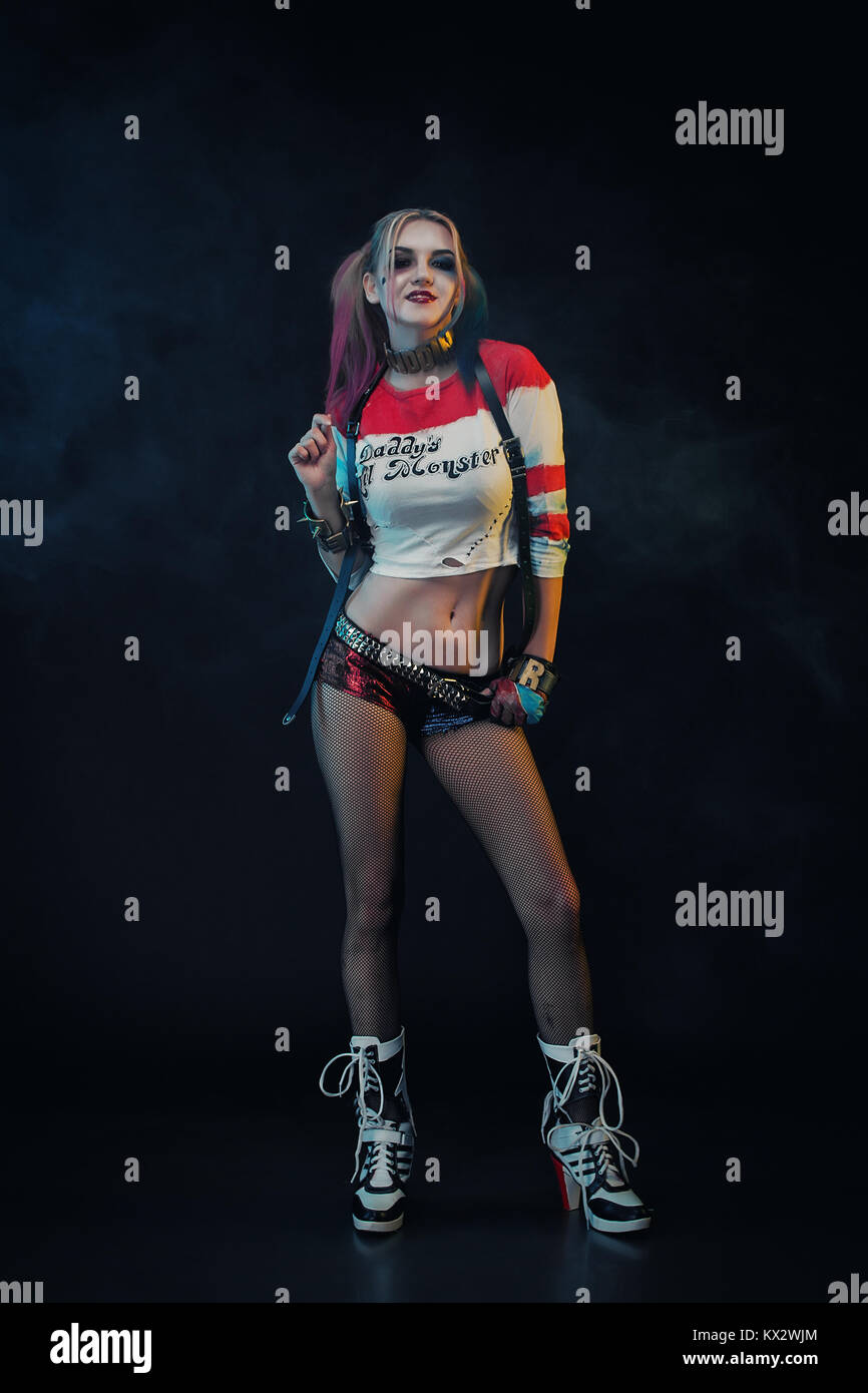 Cosplayer girl with in Harley Quinn costume. Halloween make up. Stock Photo