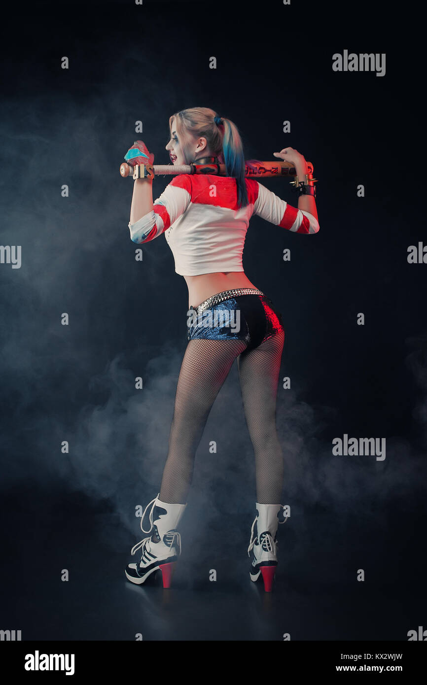 Cosplayer girl with in Harley Quinn costume. Halloween make up. Stock Photo