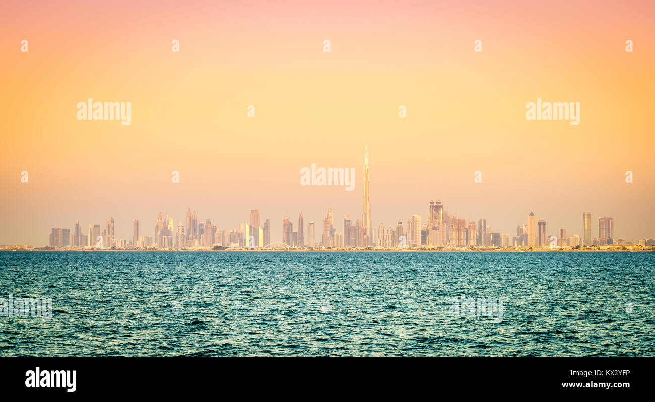 Seaside view of skyline of Dubai's downtown at sunset Stock Photo