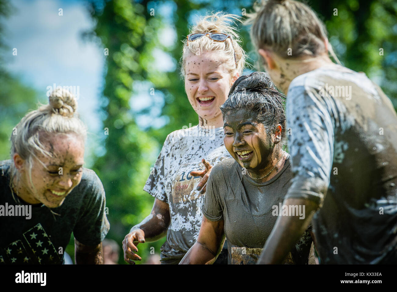 4 girls laughing covered in mud during the Pretty Muddy 5k Race for Life  charity fun run at Windsor Racecourse 2017 Stock Photo - Alamy