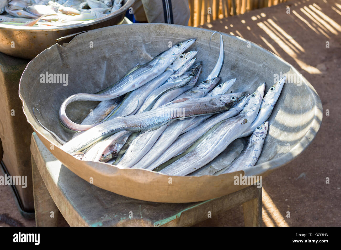 A bowl of freshly caught long silver salt water fish for sale on a Indonesia street. Stock Photo