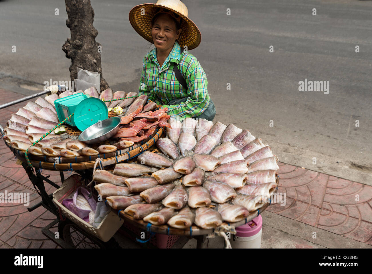 A dried fish street vendor selling here dried and smoked fish from her