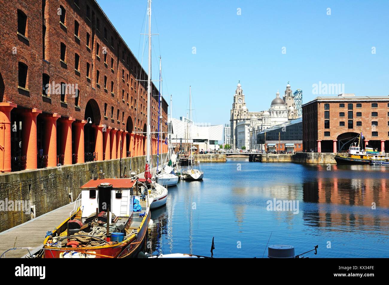 Yachts moored in Albert Dock with the Three Graces to the rear, Liverpool, Merseyside, England, UK, Western Europe. Stock Photo