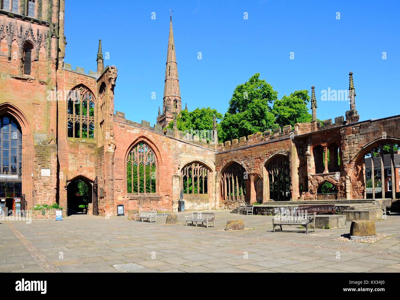 View inside the old Cathedral ruin with the Holy Trinity Church spire to the rear, Coventry, West Midlands, England, UK, Western Europe. Stock Photo