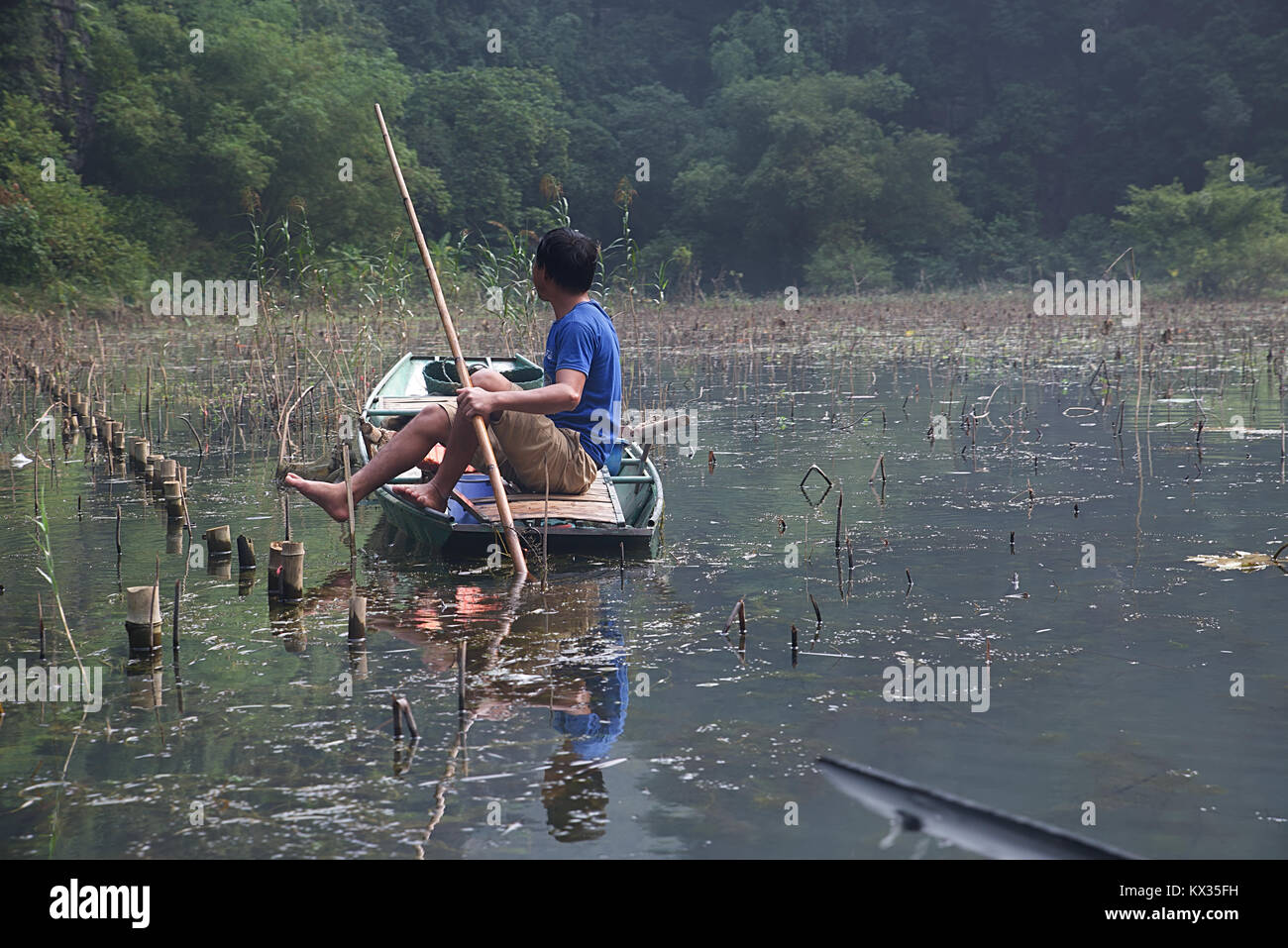 Fisherman working on the Tam Coc River Stock Photo