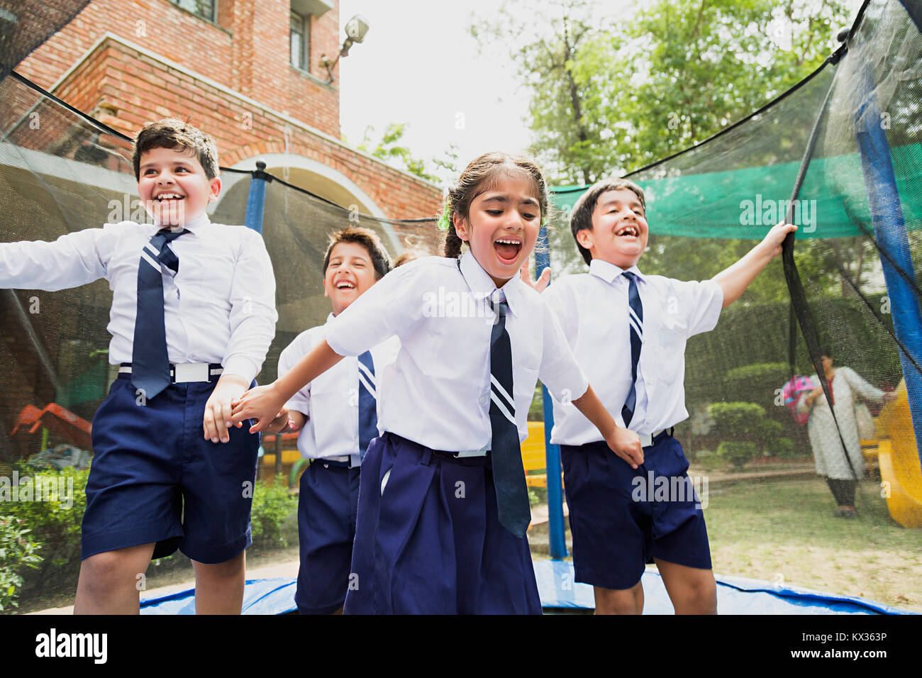 Happy School Kids Friends Trampoline Jhulla Jumping Having Fun Ground Stock Photo