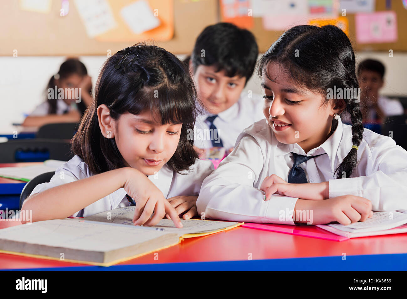 Indian School Kids Students Reading Book Studying In Classroom Stock Photo