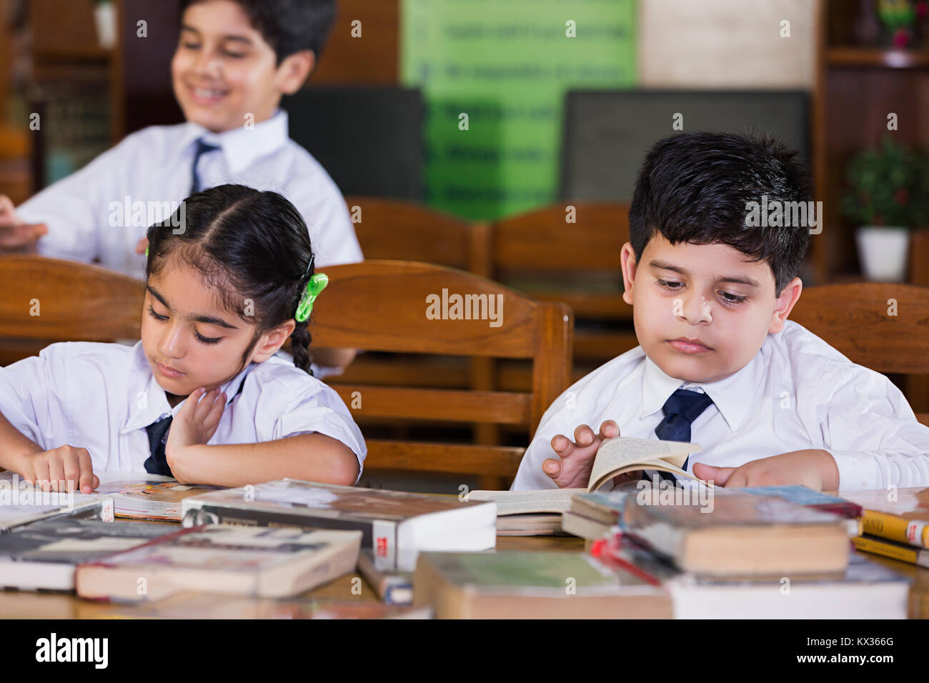 School Kids Girl And Boy Students Reading Book Studying In Library ...