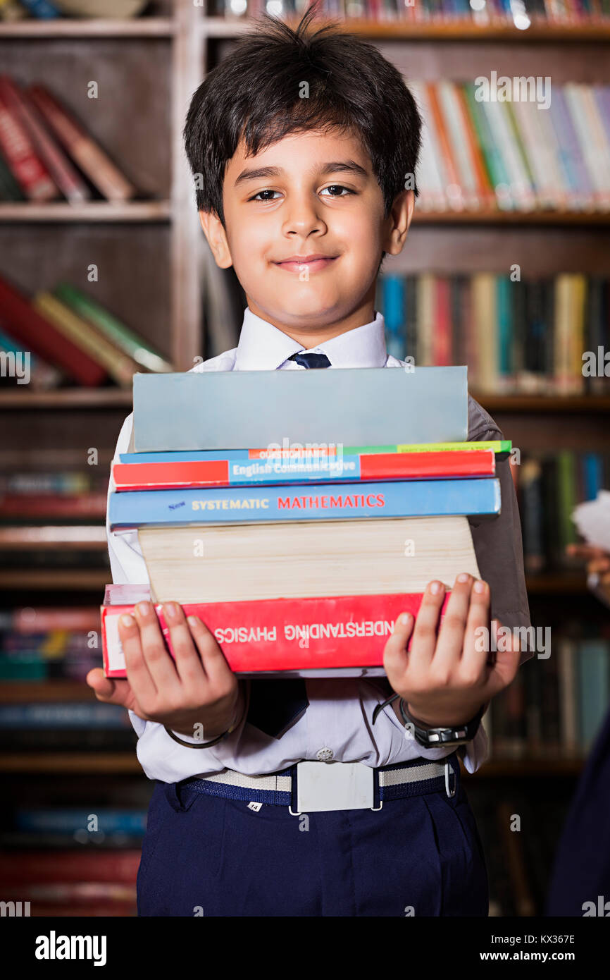 1 Indian School Little Boy Student Holding Books Studying In Library Stock Photo