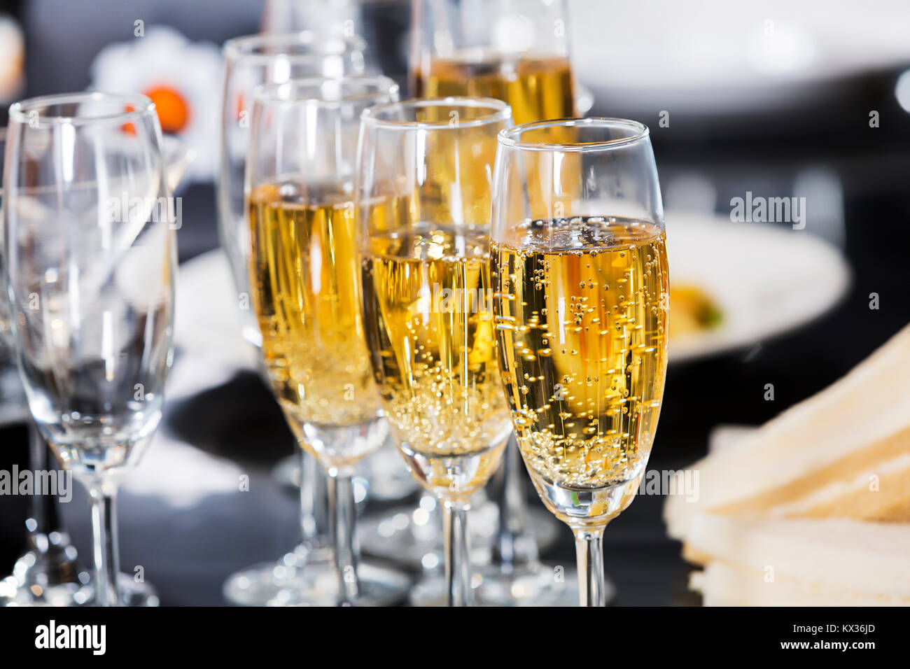 Closeup of many glasses of champagne in a row on the party table. Elegant glasses Stock Photo