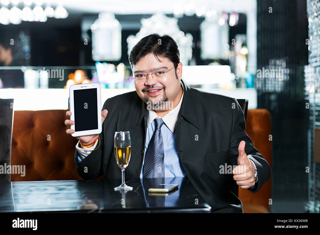 One Business Male Showing Thumbs-up With Mobile-Tablet Pc In- Restaurant Stock Photo