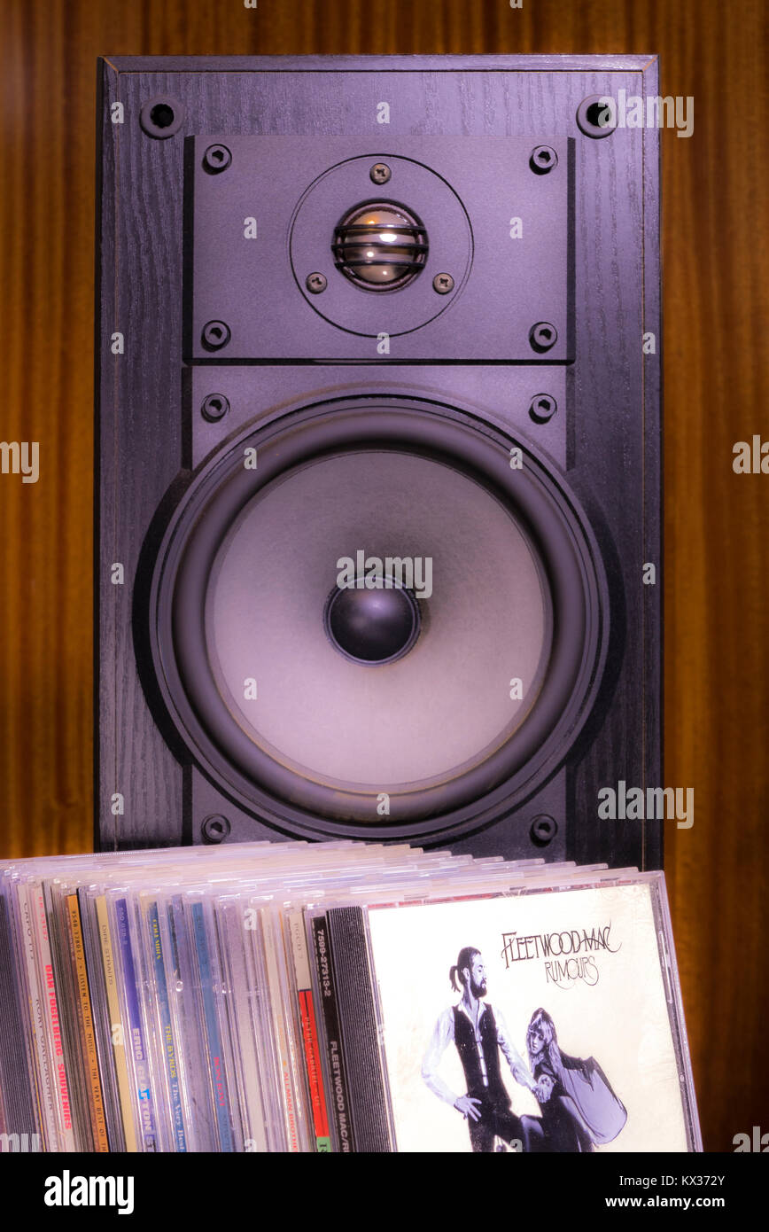 CDs in front of single black speaker cabinet, with Fleetwood Mac, Rumours album in front. General concept relating to playing or listening to music. Stock Photo