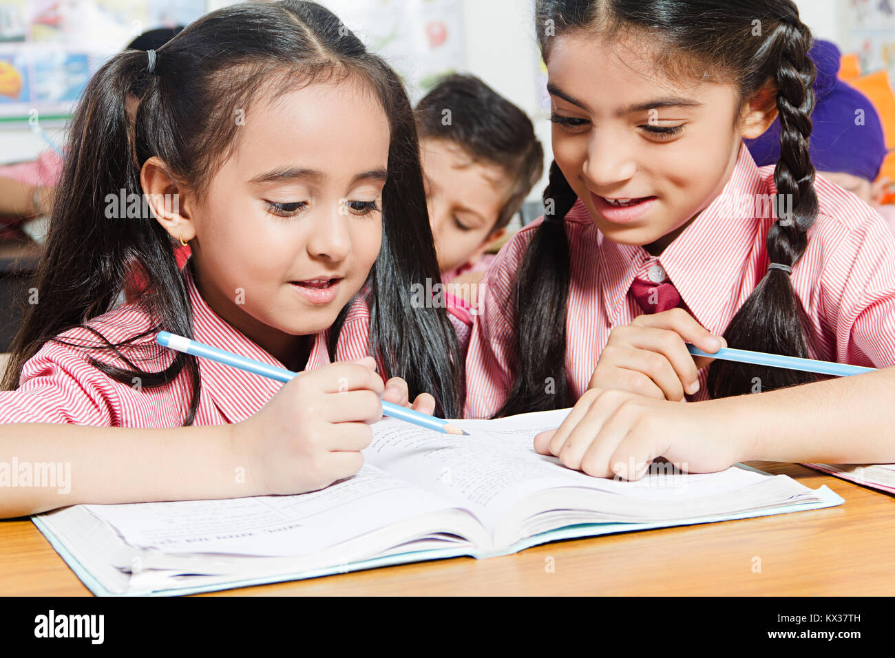 2 Indian School Kids Students Girls Book Studying In Class Stock Photo