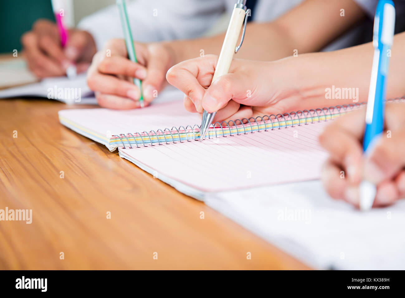 Close-Up High School Students Writing Notebook Study Education Learning Classroom Stock Photo