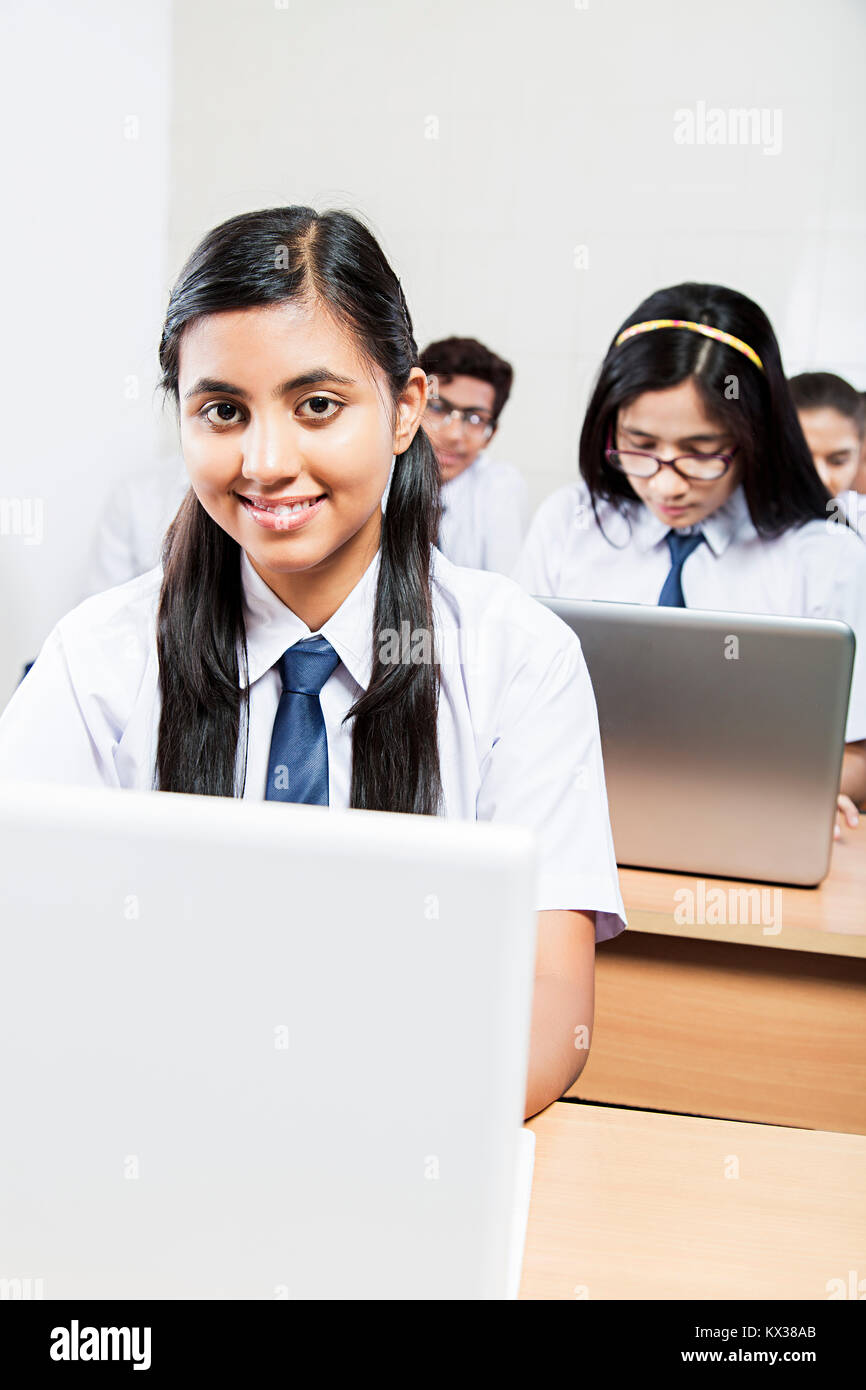 Indian High School Student Girl Using Laptop Studying In Classroom Stock Photo